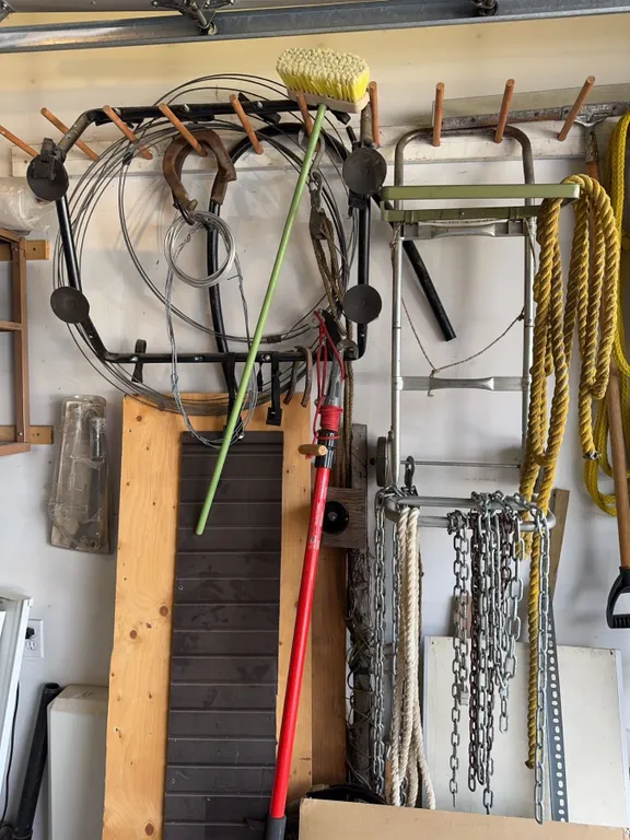 Garage Tools Including Broom, Ladder, Ropes, Chains, and Hose Reels