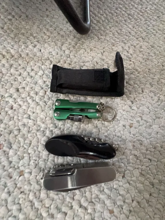 Three Multi-Tools with Black Case, Including Swiss-Style Pocket Knives