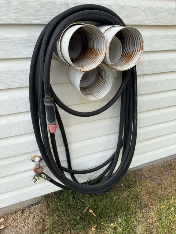 Welding Torch With Hoses and Wall-Mounted Storage