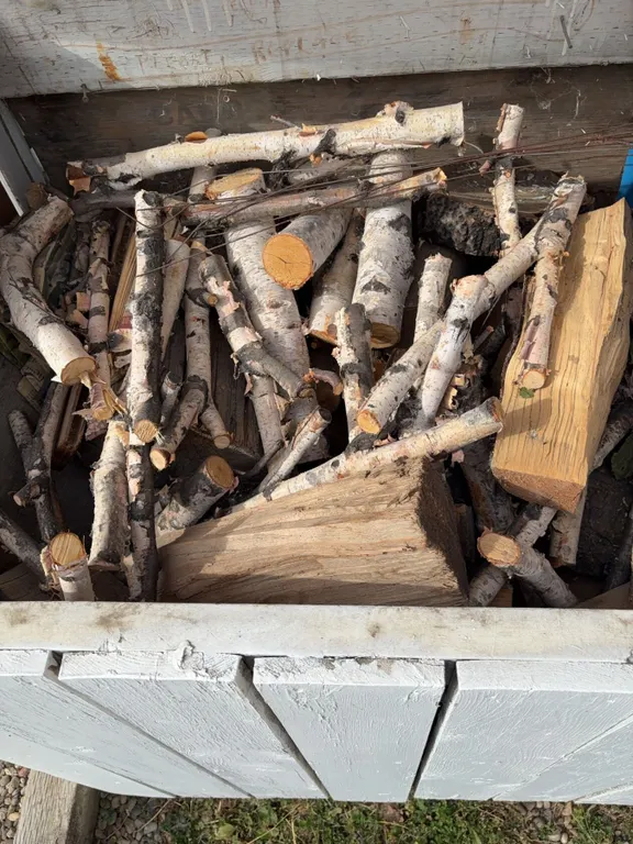 Firewood Including Birch Logs and Mixed Hardwood Pieces in White Bin