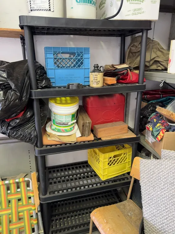 Five-Tier Black Plastic Shelving Unit with Assorted Containers and Hardware