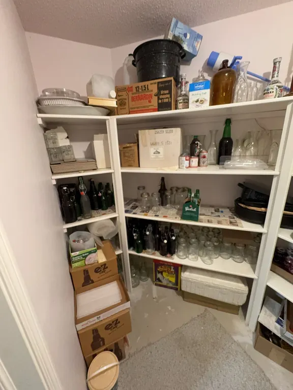Home Canning Jars, Bottles, Lids and Homebrew Supplies on White Shelving
