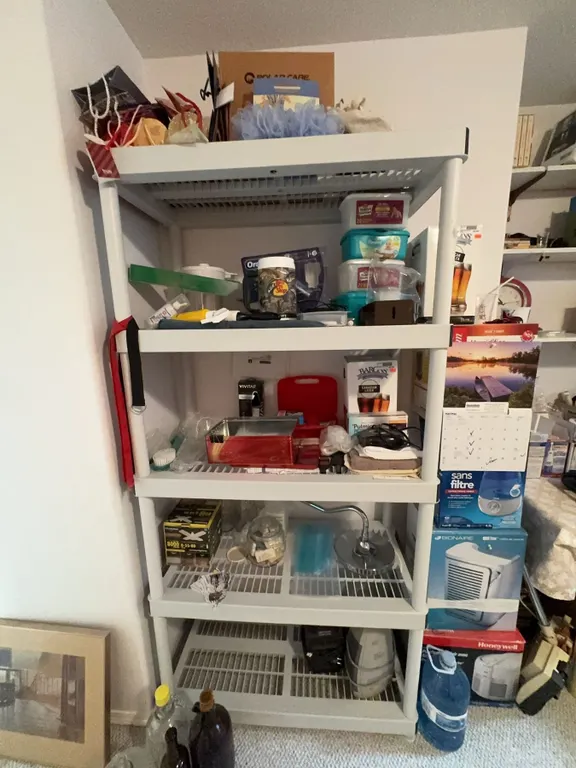 Household Storage Rack With Four Shelves and Contents