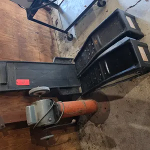 Set Of Car Ramps, Mechanic's Creeper, And Wheel Grinder Mounted On Steel Frame