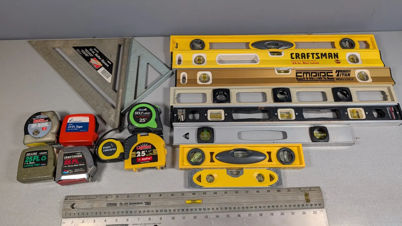 Assorted Hand Tools: Levels, Rafter Squares, and Tape Measures