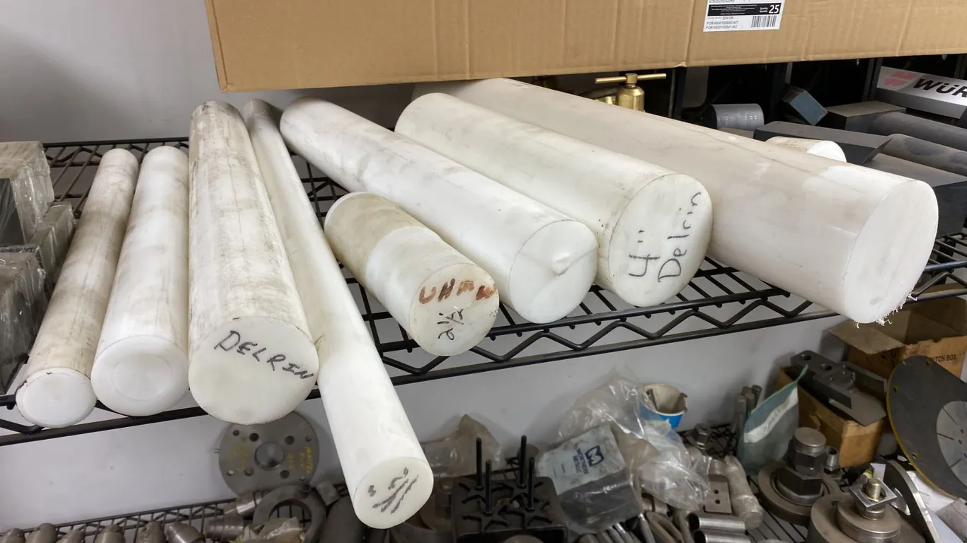 SEVERAL LENGTHS OF DELRIN PLASTIC FOR MILLING. THE LARGEST PIECE IS 8 1/4" DIAMETER X 12"
