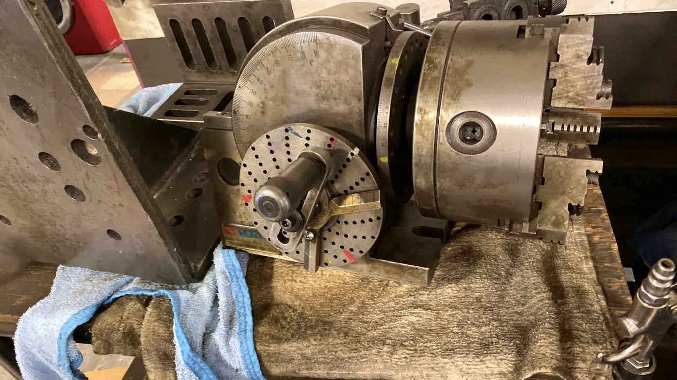 DIVIDING HEAD AND TAIL STOCK. INC METAL STAND AND OTHER TOOLING ON THE SHELVES AS SHOWN IN PHOTOS
