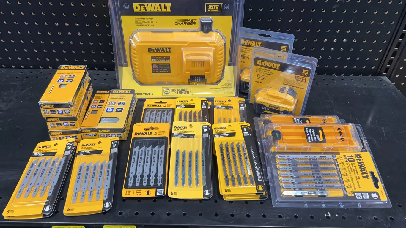 Assortment of DeWalt Batteries, Charger, Saw Blades, and Brad Nails