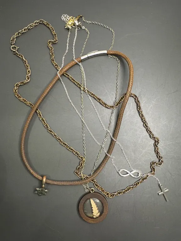 Necklaces with Various Materials, Including Leather, Metal, and Resin