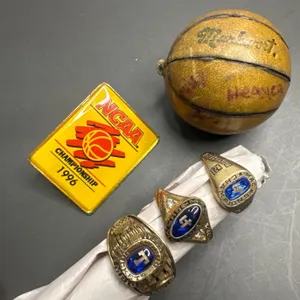 NCAA Memorabilia Including Championship Rings, Pin, and Mini Basketball