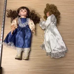 Praying girl & misc. doll
