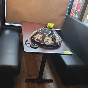 Restaurant booth set. Includes laminate tabletop with black metal pedestal bases and (2) black vinyl padded benches. Table measures 60" x 30". Benches