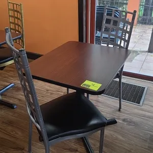 Restaurant table and chairs set. Includes 24" x 30" woodgrain laminate top table mounted on a black metal pedestal X-base and (2) silver-tone metal fr