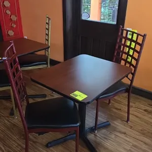 Table and chairs set. Includes (1) 24" x 30" woodgrain-finish laminate top table with rounded corners mounted on a black metal pedestal X-base and (2)
