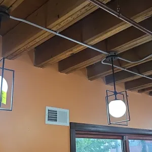 Metal pendant lights. Features black metal geometric open cage frames with spherical frosted globe diffusers, downrods, and ceiling canopies. 10" x 28