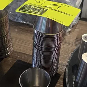 Stainless steel condiment holders. Features a stackable round design with rolled rims.