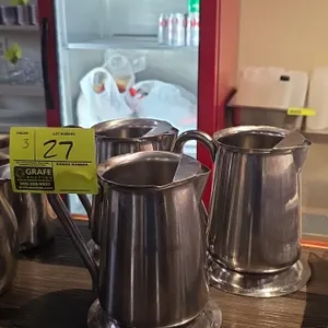 Vollrath stainless steel pitchers. Features 18-8 stainless steel construction, integrated ice guards, side handles, and pedestal bases.