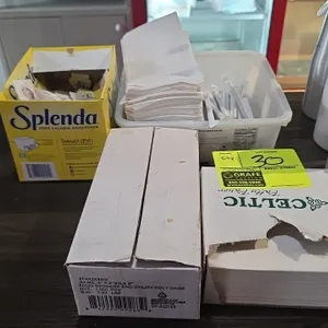 Assorted restaurant and kitchen supplies. Includes Celtic patty paper, food storage poly bags (4" x 2" x 8"), Splenda and sugar packets, wrapped drink