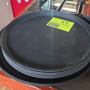 Round poly serving trays. Features black textured non-skid surface and raised rim. Includes 14" and 16" diameter trays.