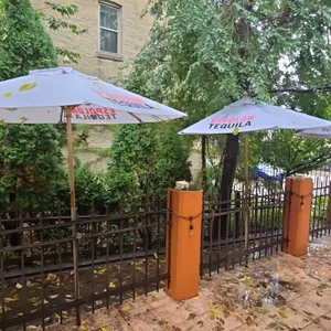 Espolòn Tequila patio umbrellas. Features white cloth canopies with printed Espolòn Tequila branding, wooden pole and rib construction, and decorative