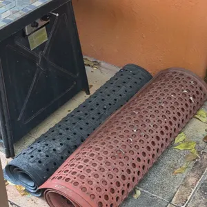 Assorted rubber drainage floor mats. Features perforated rubber construction with drainage holes and anti-slip textured surfaces. Includes (1) red mat