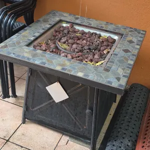 Propane gas fire table. Features stone tile mosaic top, burner ring with lava rocks, push-button ignition, control knob, and metal cabinet base with h