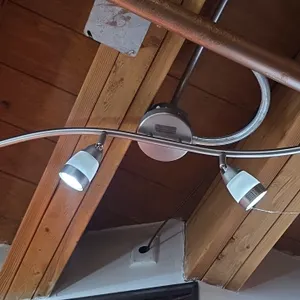 4-head LED spot light fixtures. Features curved bar design with brushed metal finish, (4) adjustable directional spotlight heads, and frosted glass sh