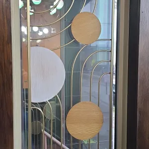 Metal wall decor panels. Features gold-tone metal frames with curved geometric wire designs and round wood-tone accent discs. 15" x 36".