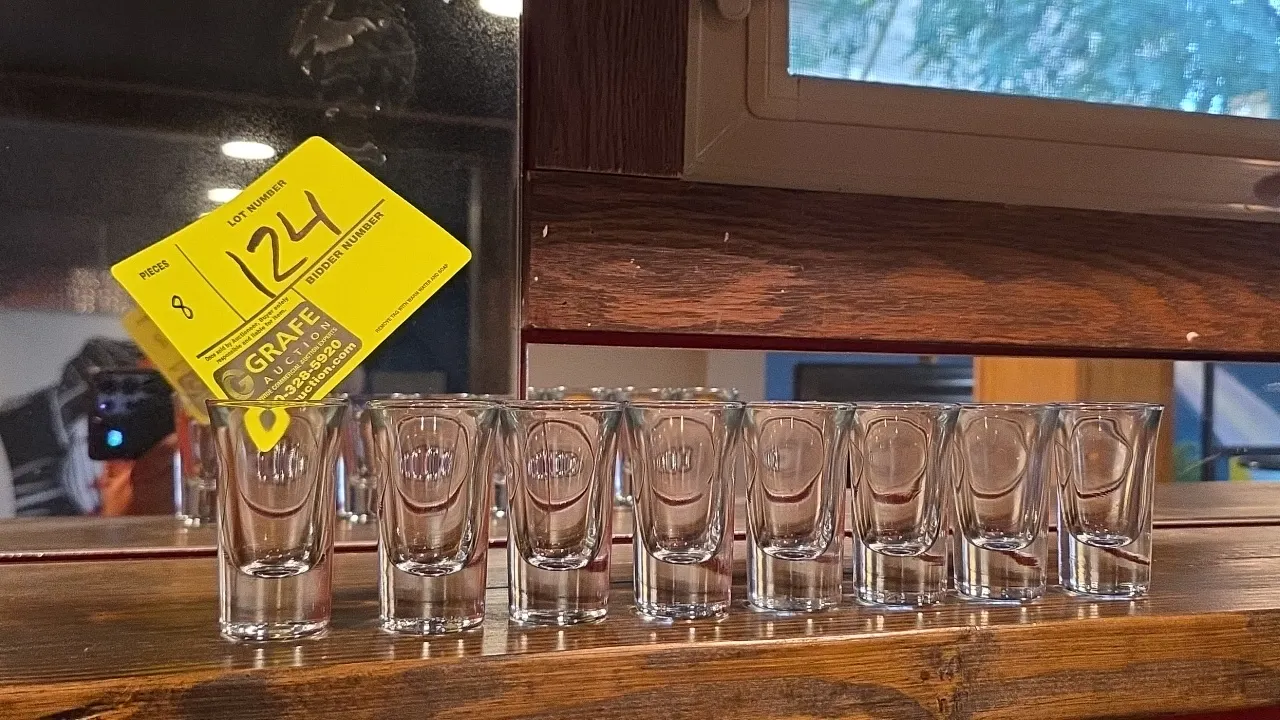 Clear glass shot glasses. Features clear glass construction with faceted sides and a heavy base.