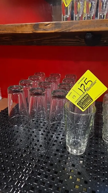 Glass pint glasses. Features clear glass construction with a tapered conical profile and thick base.