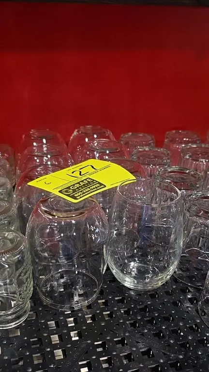 Stemless wine glasses. Features clear glass construction. Surrounding glassware and background items not included.