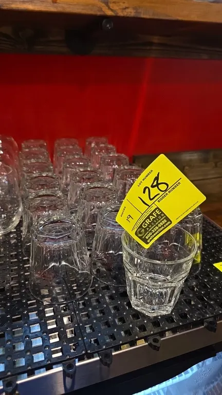 Faceted glass beverage tumblers. Features clear pressed glass construction with a paneled lower body. Other glassware and matting not included.