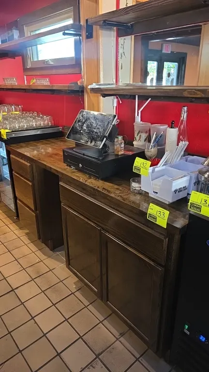 Solid wood service counter with storage. Features wood countertop, three side drawers, one wide upper drawer, two-door lower storage cabinet, and cent