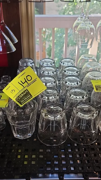 Glass beverage tumblers. Features clear glass construction with faceted panel sides and heavy bases.