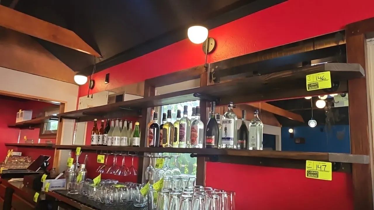 Solid wood wall shelves. Features metal pipe mounting brackets and under-shelf hanging wine glass rack attachments. Dimensions: 9'9"L and 11.5'L. Wall
