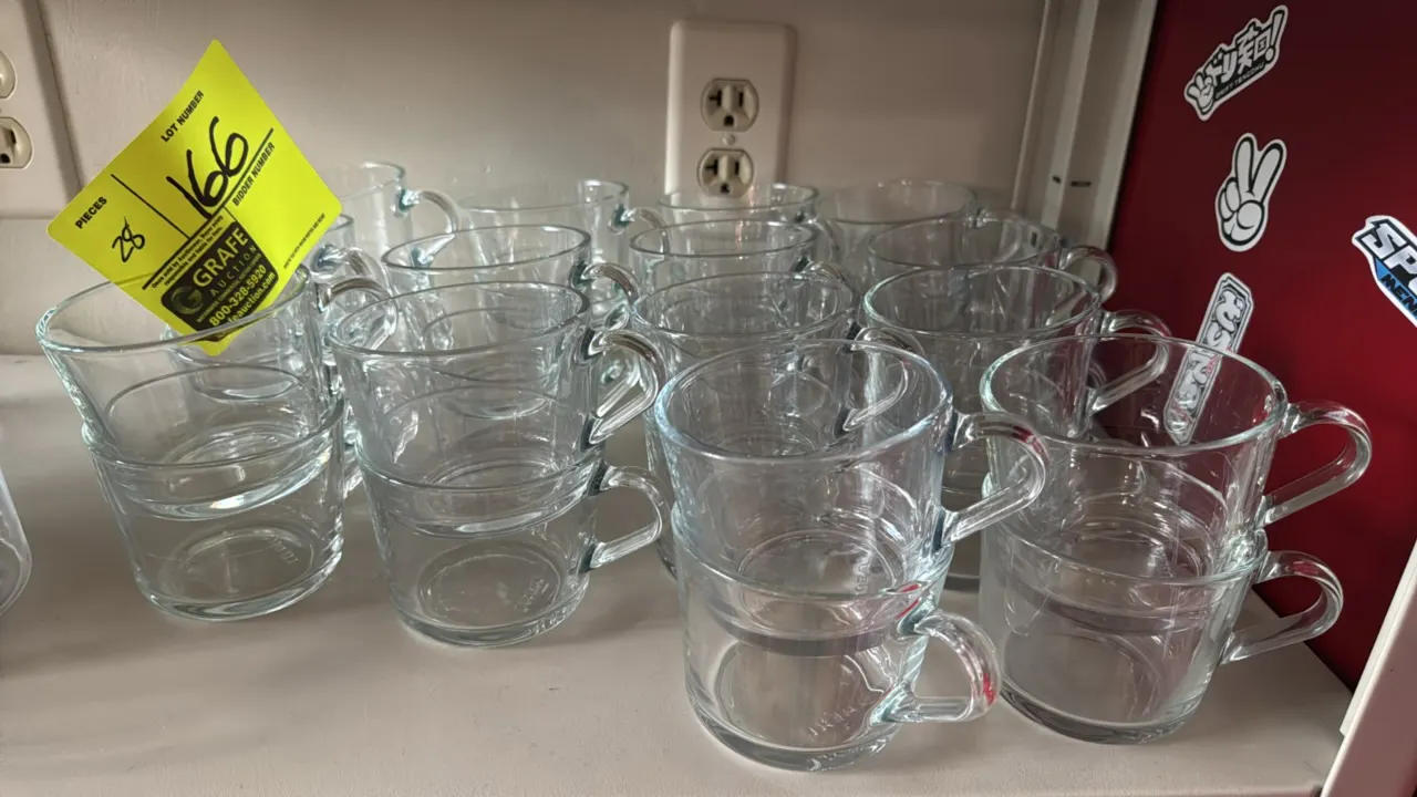 Clear glass tea cups. Features integrated side handles and stackable design.