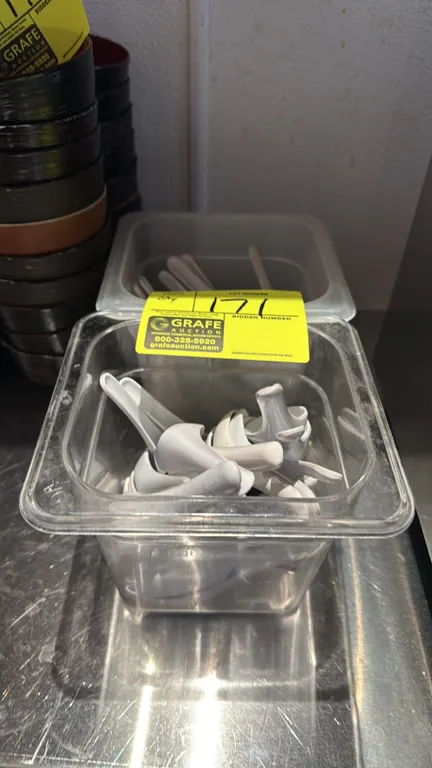 Bulk lot of plastic soup spoons. Includes (2) 1/6 size plastic food pans with white plastic Asian-style soup spoons. Bowls in background not included.