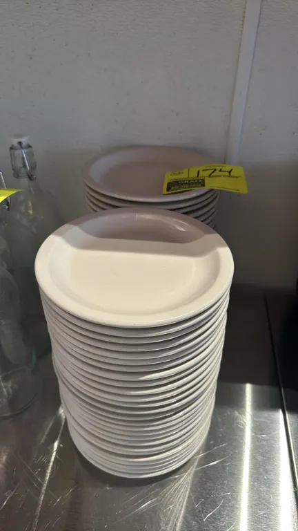 Lot of (53) ITI china plates. Features off-white ceramic construction with a wide rolled rim. Dimensions: 7"Dia.