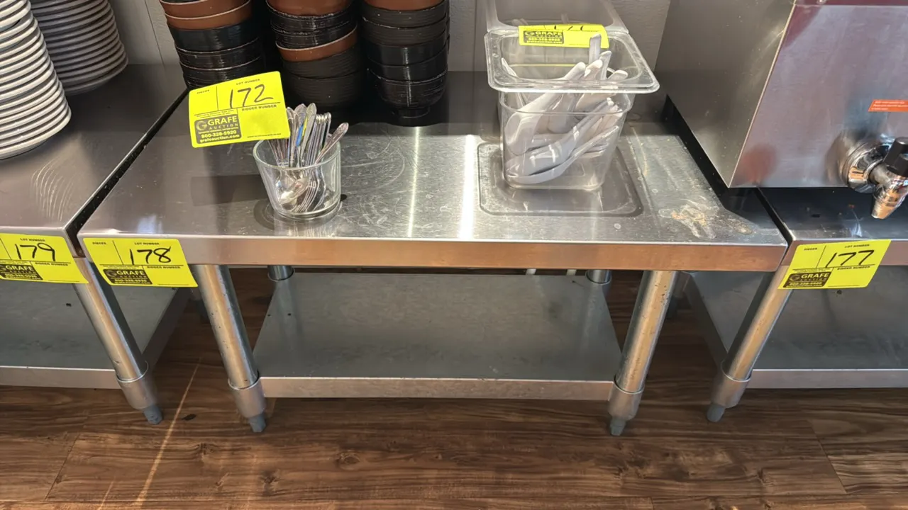 Stainless steel equipment stand. Features a galvanized lower undershelf and galvanized legs with adjustable bullet feet. 30" x 18" x 19". Contents not