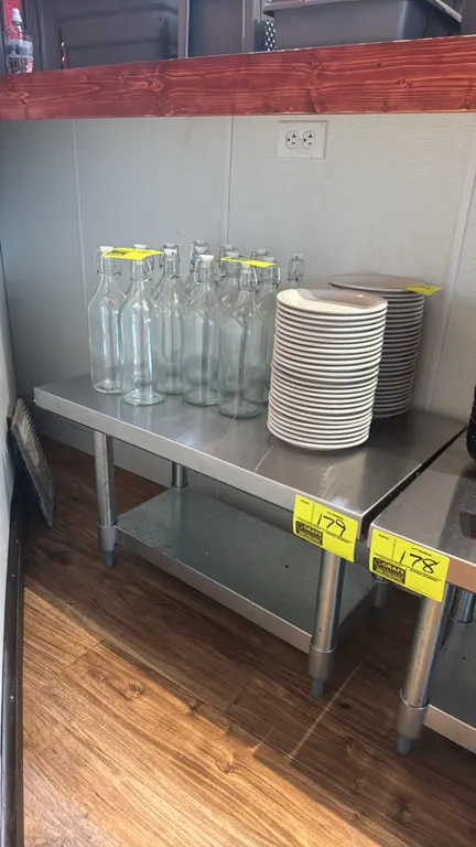 Stainless steel equipment stand. Features a stainless steel top and galvanized undershelf. 30"L x 18"W x 19"H. Mounted on galvanized legs with adjusta