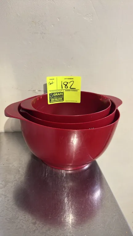 KitchenAid nesting poly mixing bowl set. Includes (3) nesting bowls featuring red plastic construction, integrated side handles, and pour spouts. 7" t