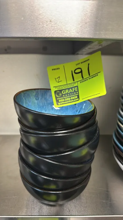 Vancasso stoneware bowls. Features a mottled blue reactive glaze interior and a smooth black exterior finish. 4 1/2"Dia.