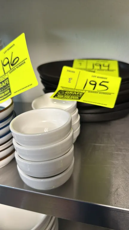 Porcelain condiment bowls. Features white glazed finish and maker's mark on the underside. 2 1/2" dia.