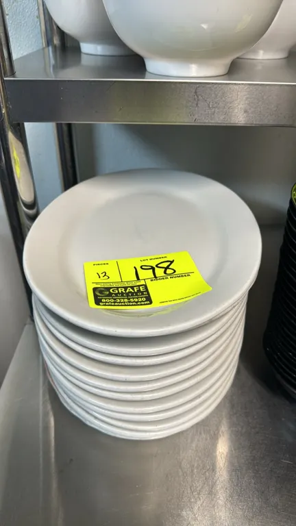Oval china dinner plates. Features ceramic construction with a wide rim design. Dimensions: 12 1/2"L.