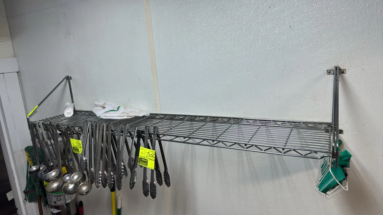 Chrome wire wall-mount shelves. Features wire grid shelving with wall mounting support brackets. 60" x 12". Contents not included.