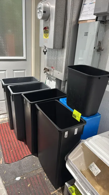 Assorted polyethylene trash cans and waste containers. Includes tall slim rectangular cans, a desktop wastebasket, and a blue container. Molded plasti