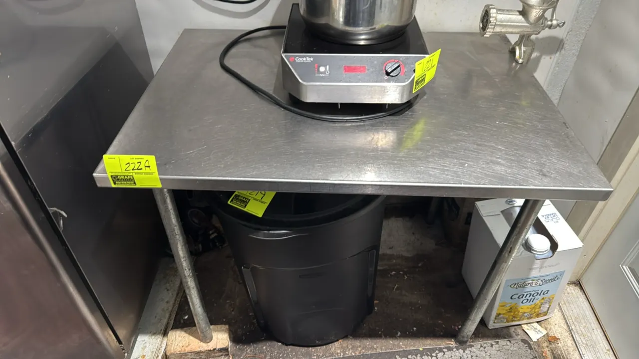 Stainless steel work table. Includes (4) unattached casters. Dimensions: 42" x 30". Mounted on tubular metal legs. Note: Casters show rust. Cooktop, p