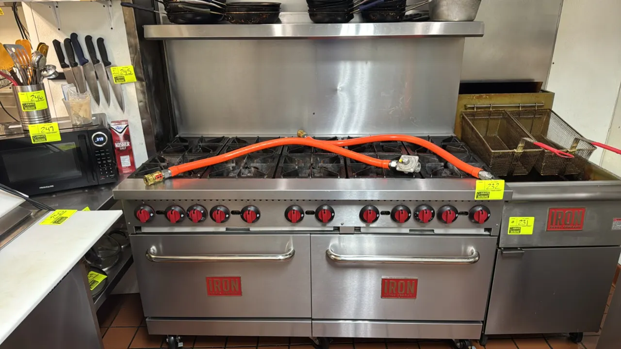 2023 Iron Range Co. IR-10B 60" 10-burner natural gas range. Features stainless steel construction, (2) standard ovens, and backguard with overshelf. I