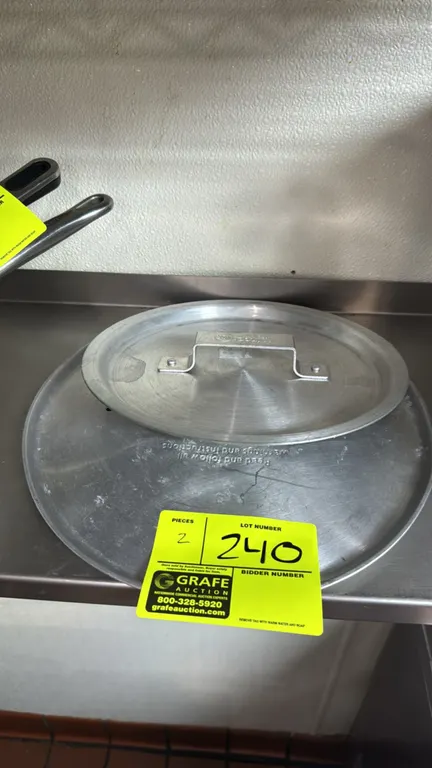Winco and assorted aluminum pot lids. Features riveted loop handles and aluminum construction. Includes 9" and 12" lids.