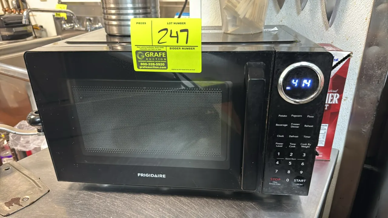 Frigidaire countertop microwave. Features digital touchpad controls, LED display, preset cooking functions, interior lighting, and rotating glass turn